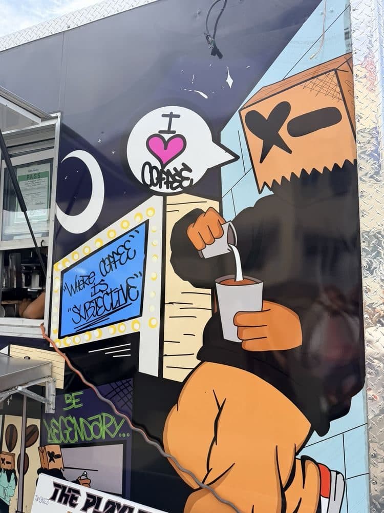 Bagman, The Compound’s paper-bag character, pouring milk into a coffee